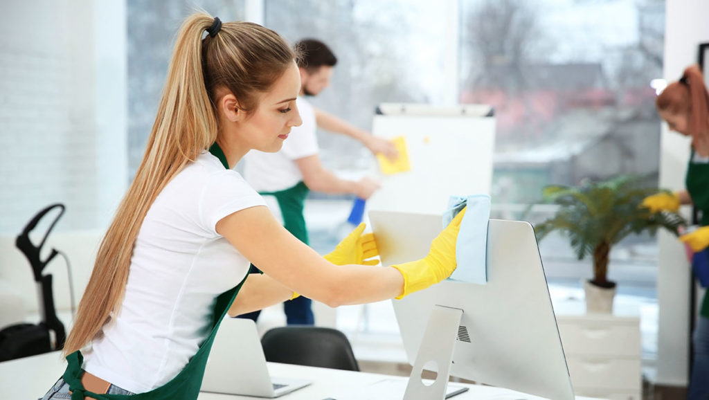 Young female worker cleaning office